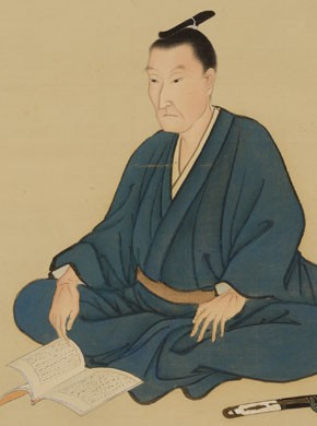 吉田松陰の肖像画。書物を手に正座する姿で描かれている